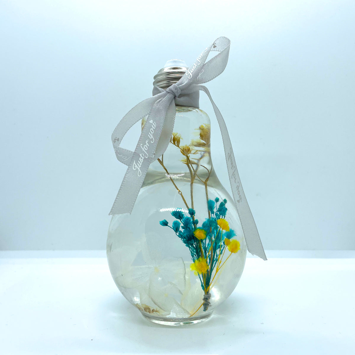 Clear blue-green floating flowers (light bulb shape)