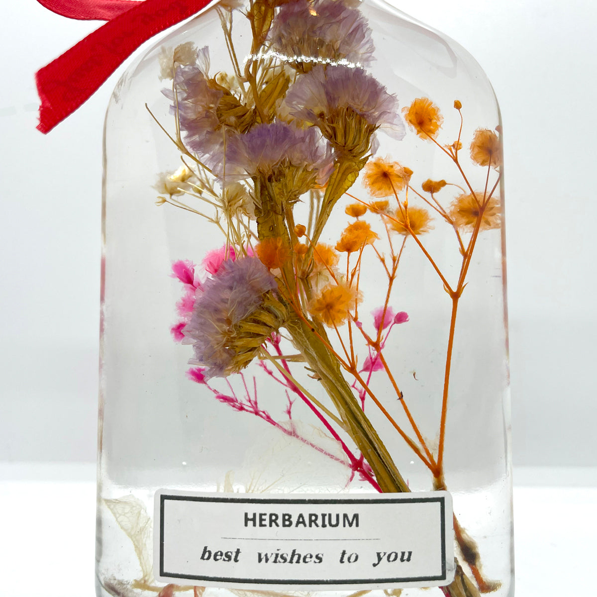 Clear purple yellow pink floating flowers (whiskey glass bottle)