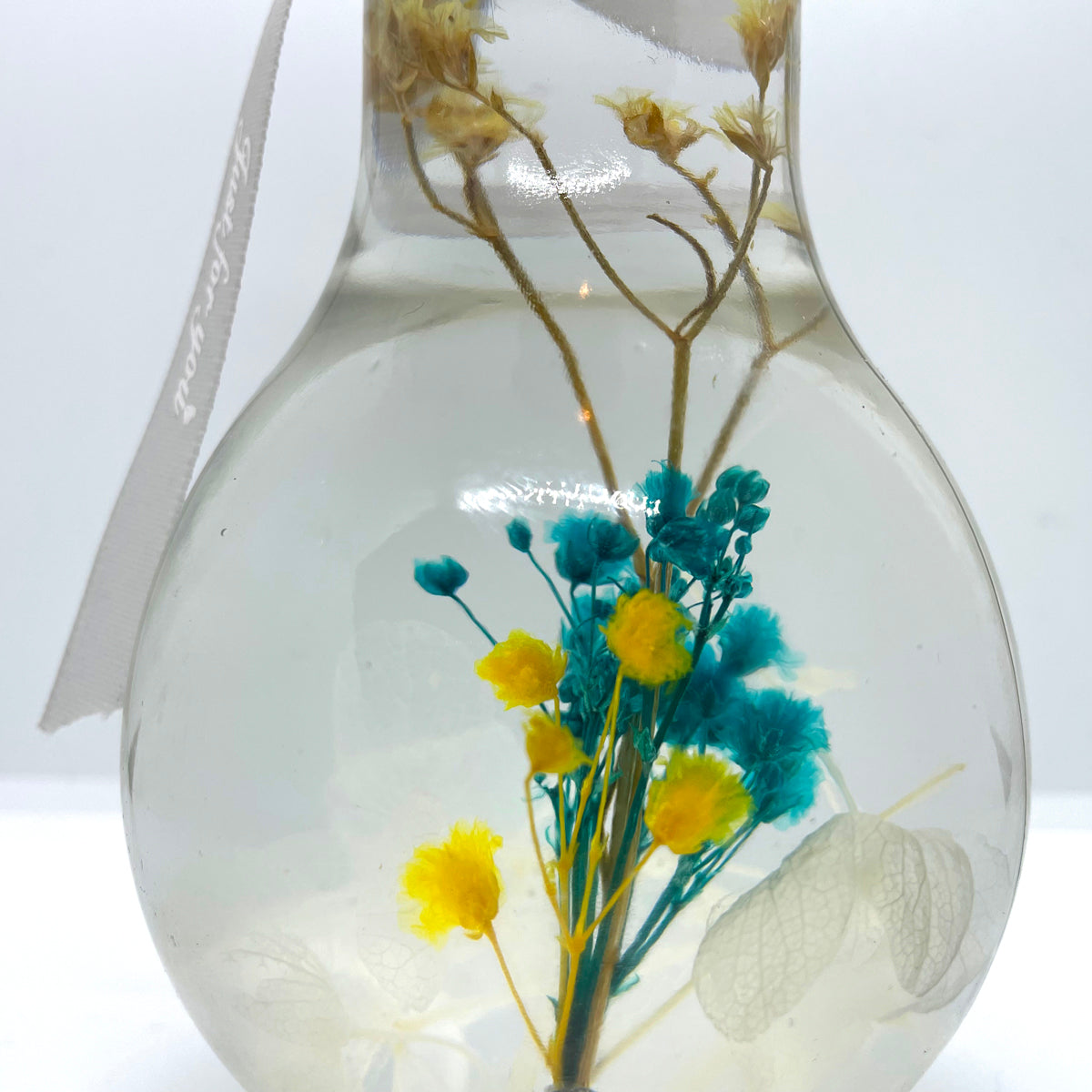 Clear blue-green floating flowers (light bulb shape)