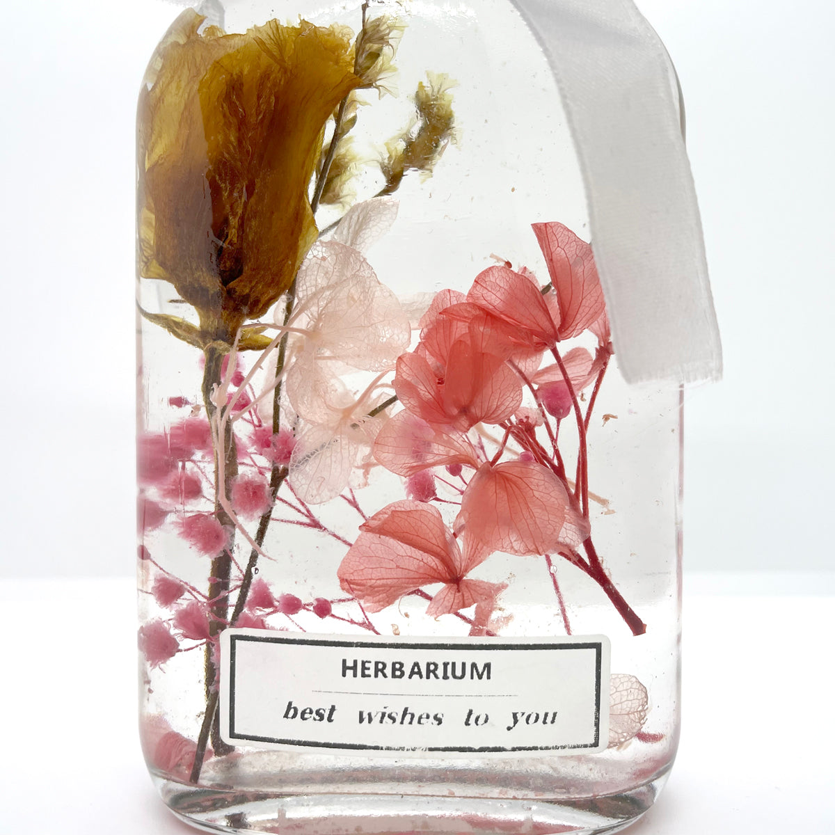 Clear small yellow flower pink floating flower (whiskey glass bottle)