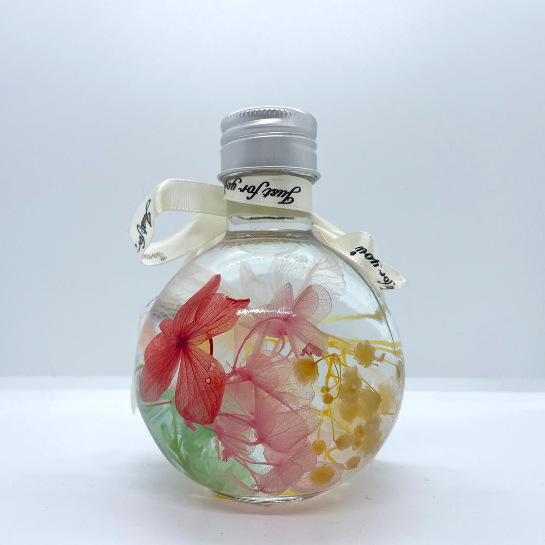 Clear green-yellow-pink floating flowers (shaped in a bottle)